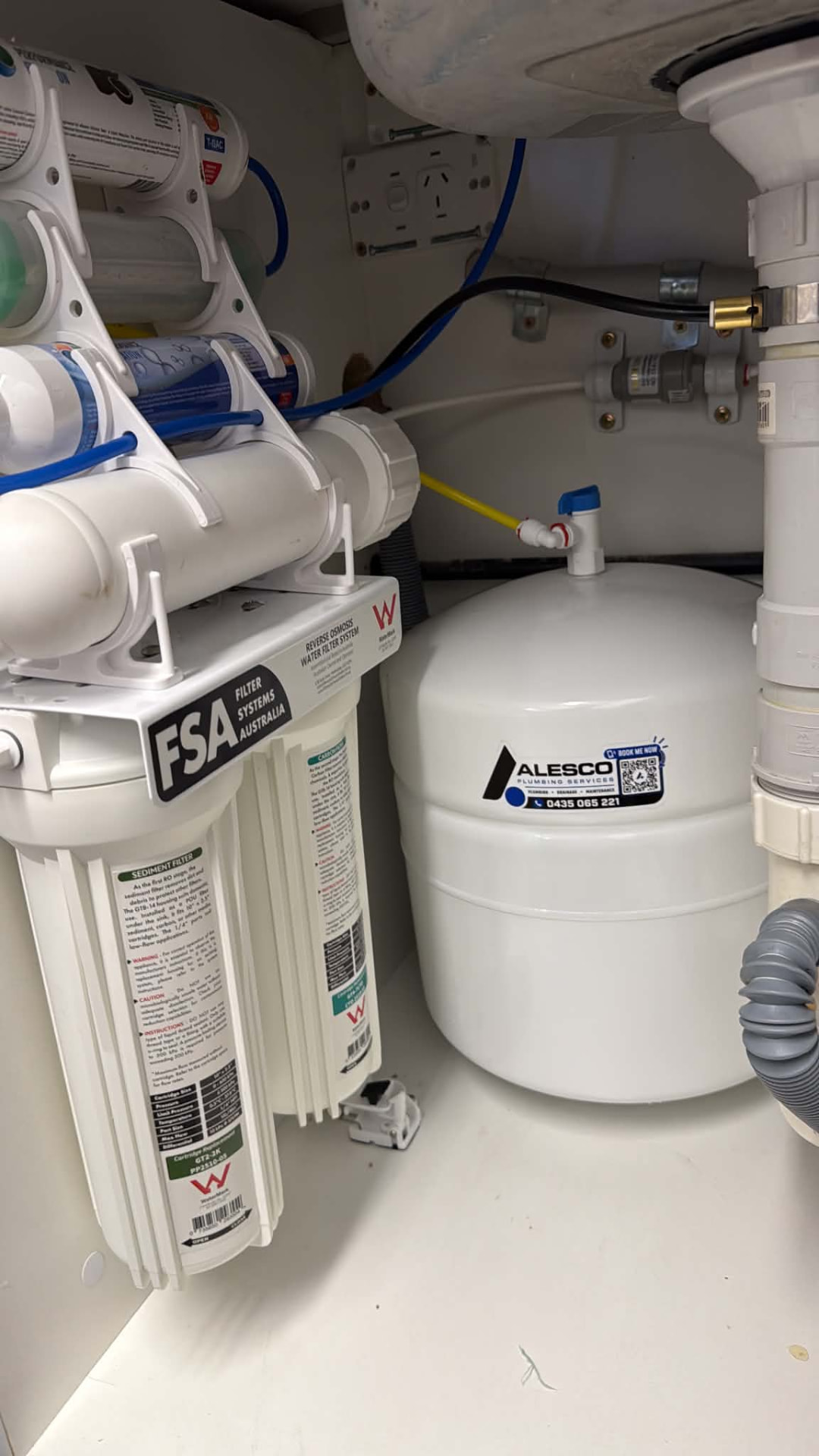 Undersink reverse osmosis filtration system installed under a kitchen sink by Alesco